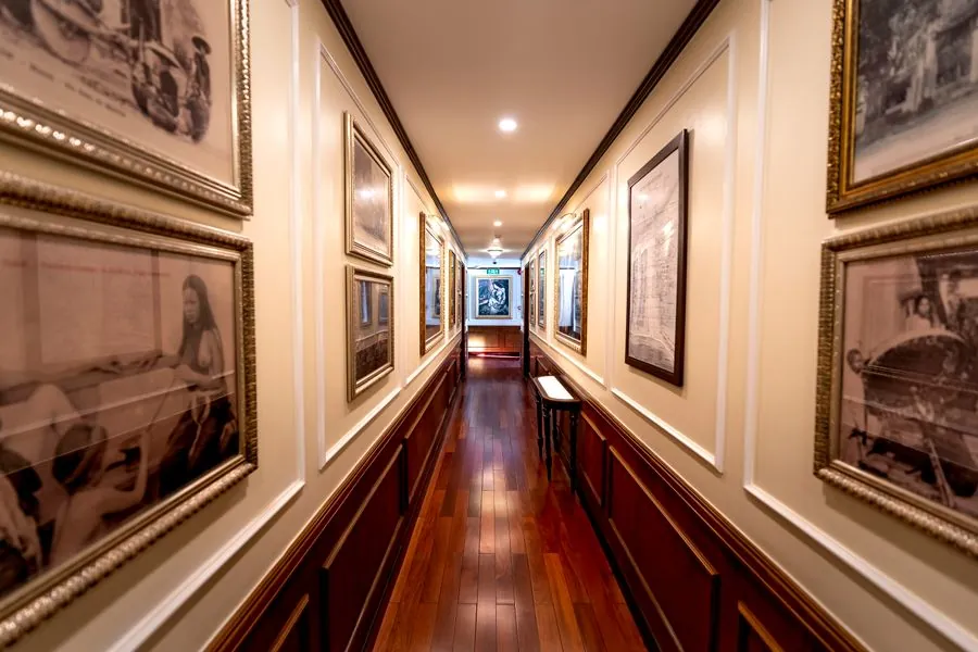 A long hallway hung with framed prints